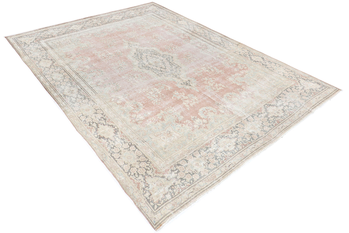 A hand-knotted 10x13 vintage wool rug featuring a blush colour combination.