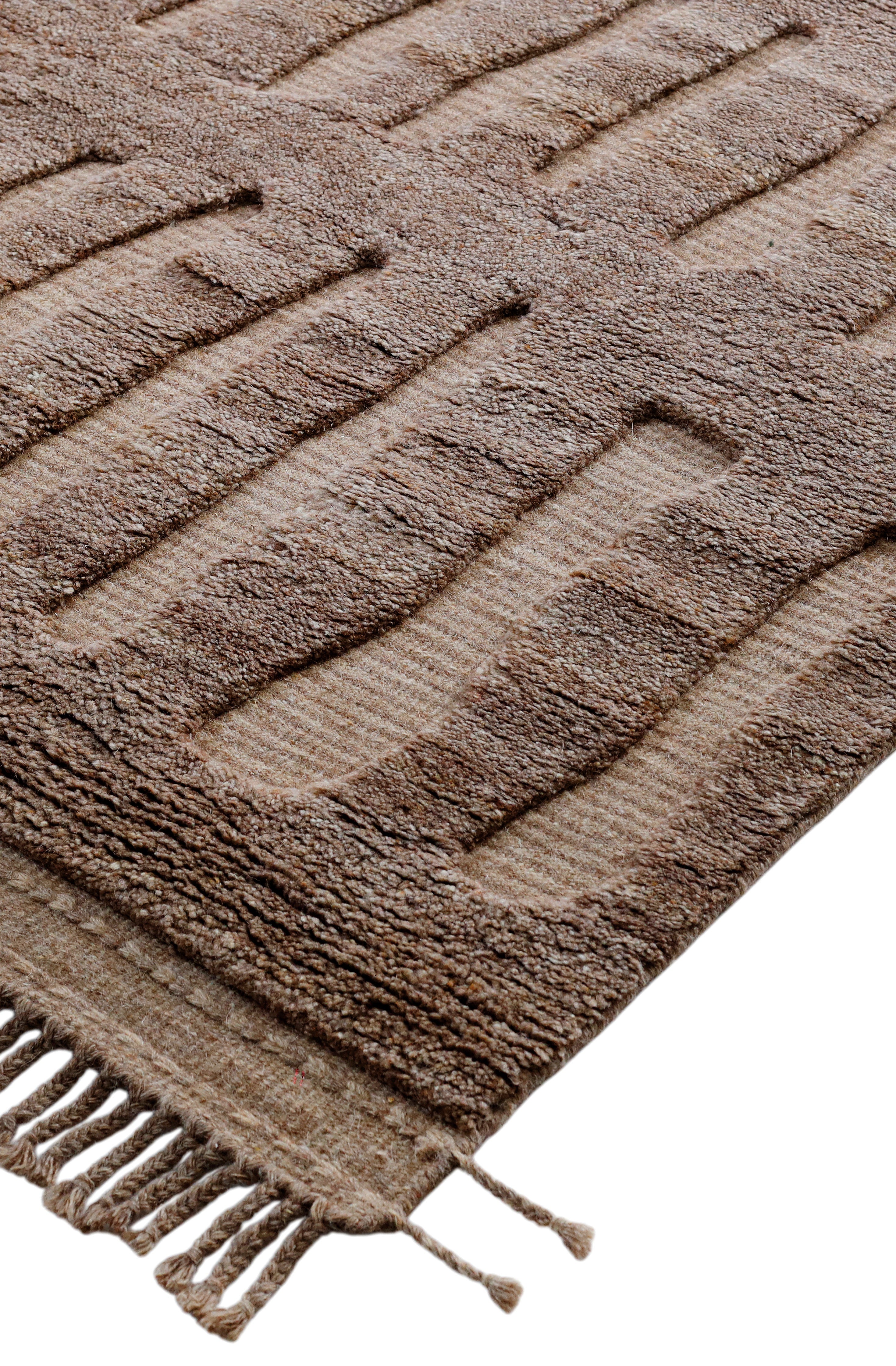 A hand-knotted modern wool rug in a neutral colour combination and pattern.