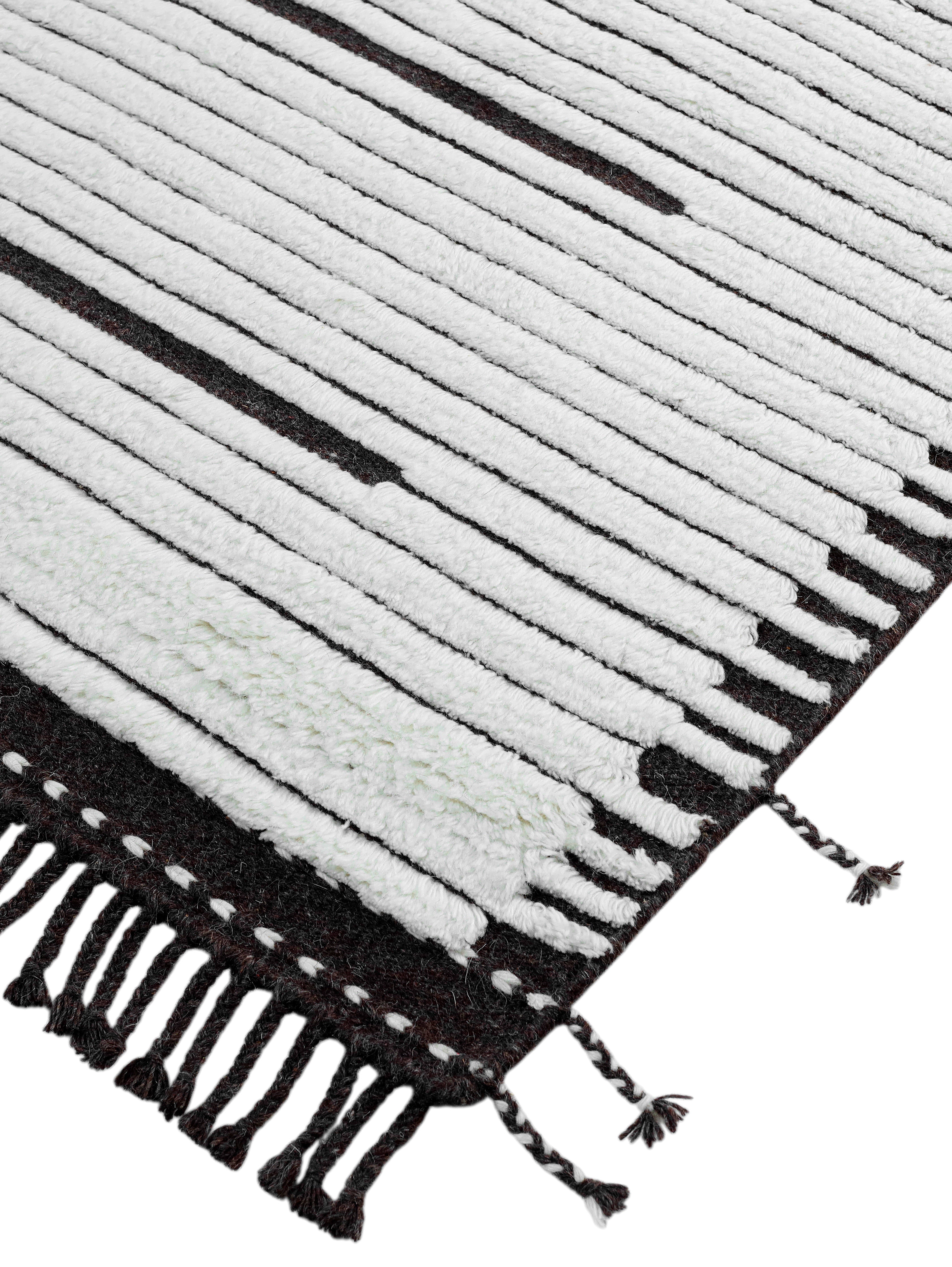 A hand-knotted modern wool rug in a neutral colour combination.
