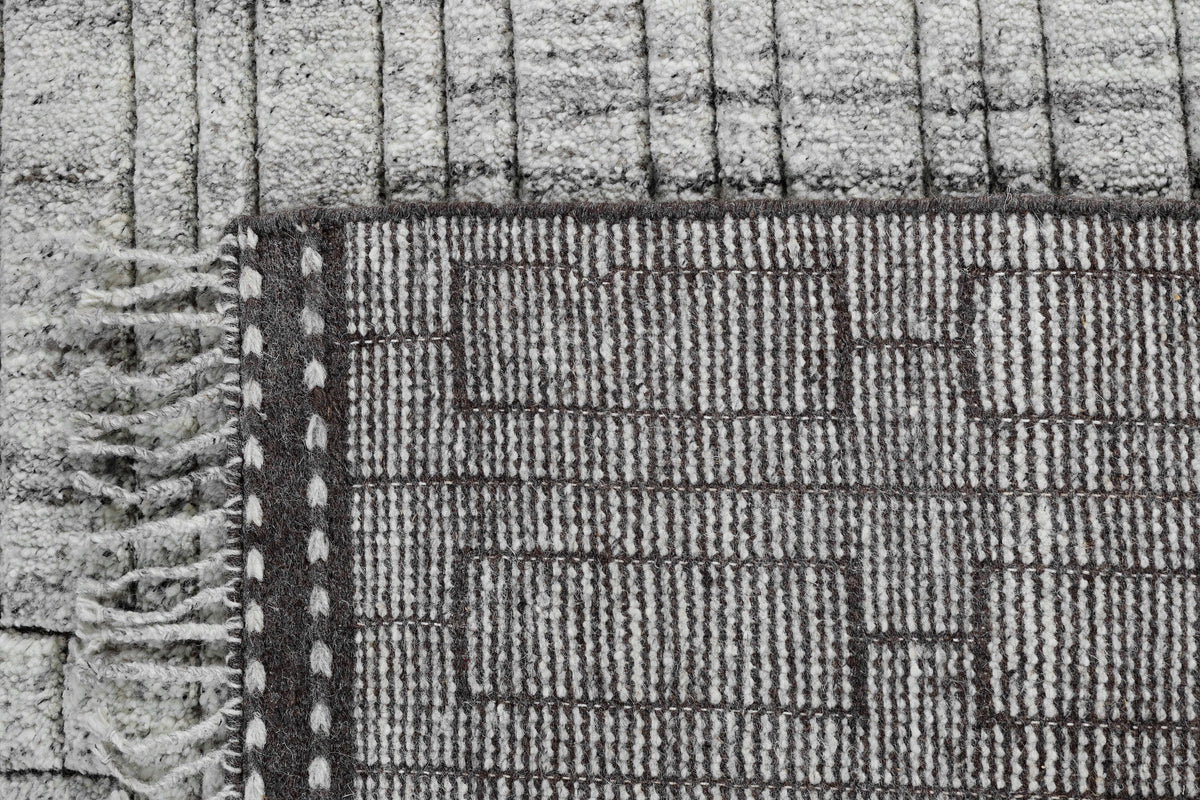 A hand-knotted modern wool rug in a neutral grey colour combination.