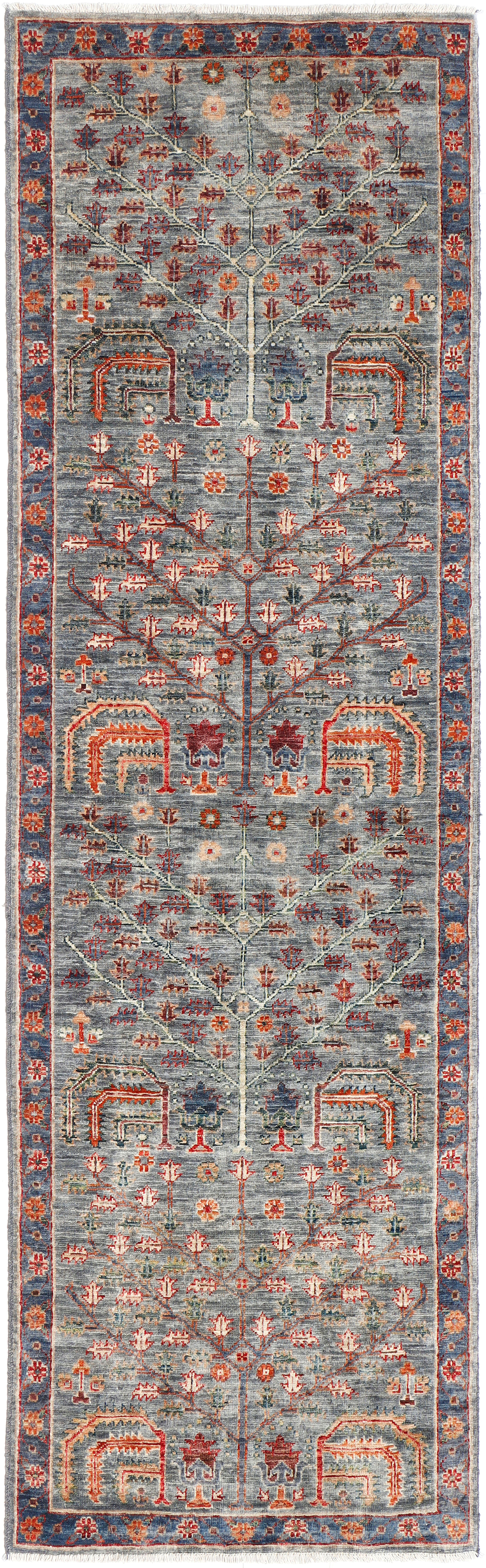 A handmade wool runner rug featuring a classic tribal pattern in a modern colour combination.