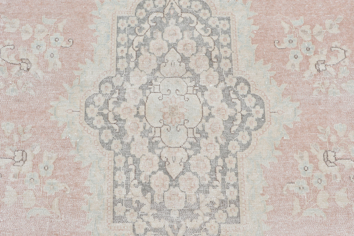 A hand-knotted 10x13 vintage wool rug featuring a blush colour combination.