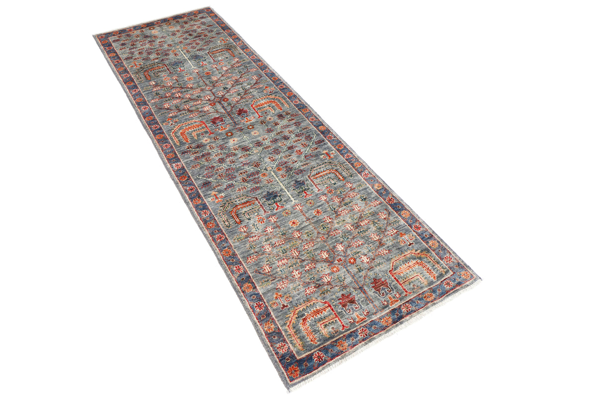 A handmade wool runner rug featuring a classic tribal pattern in a modern colour combination.