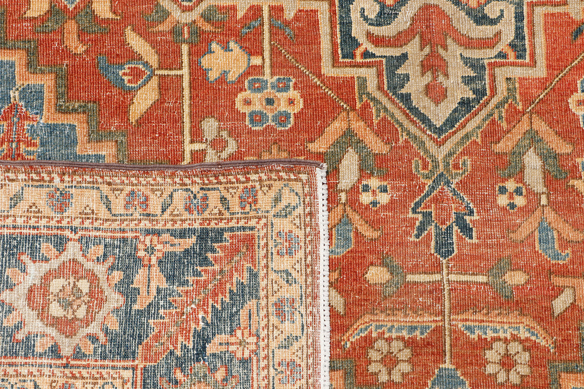 A hand-knotted antique-style wool rug featuring a classic Serapi design.