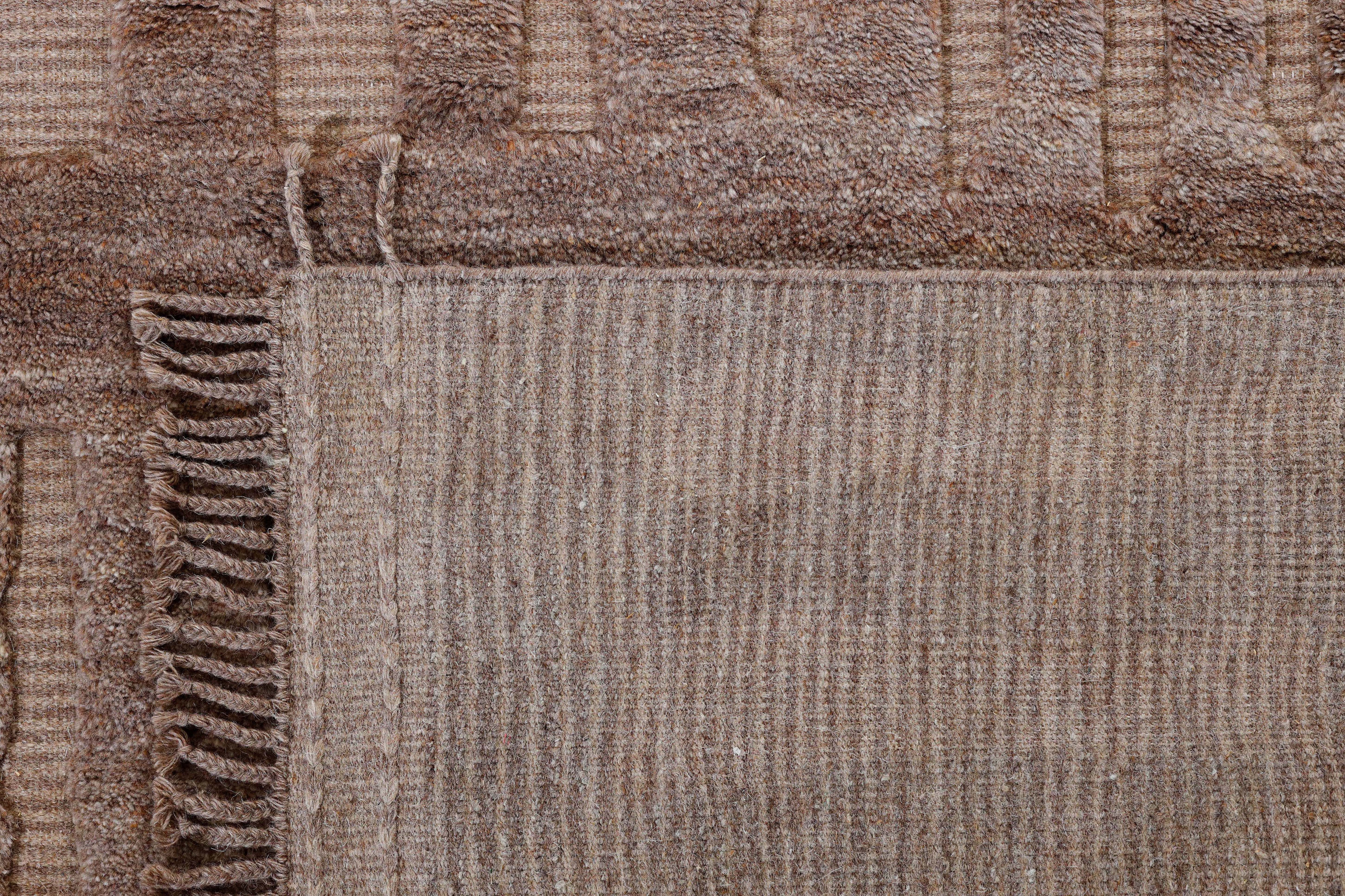 A hand-knotted modern wool rug in a neutral colour combination and pattern.