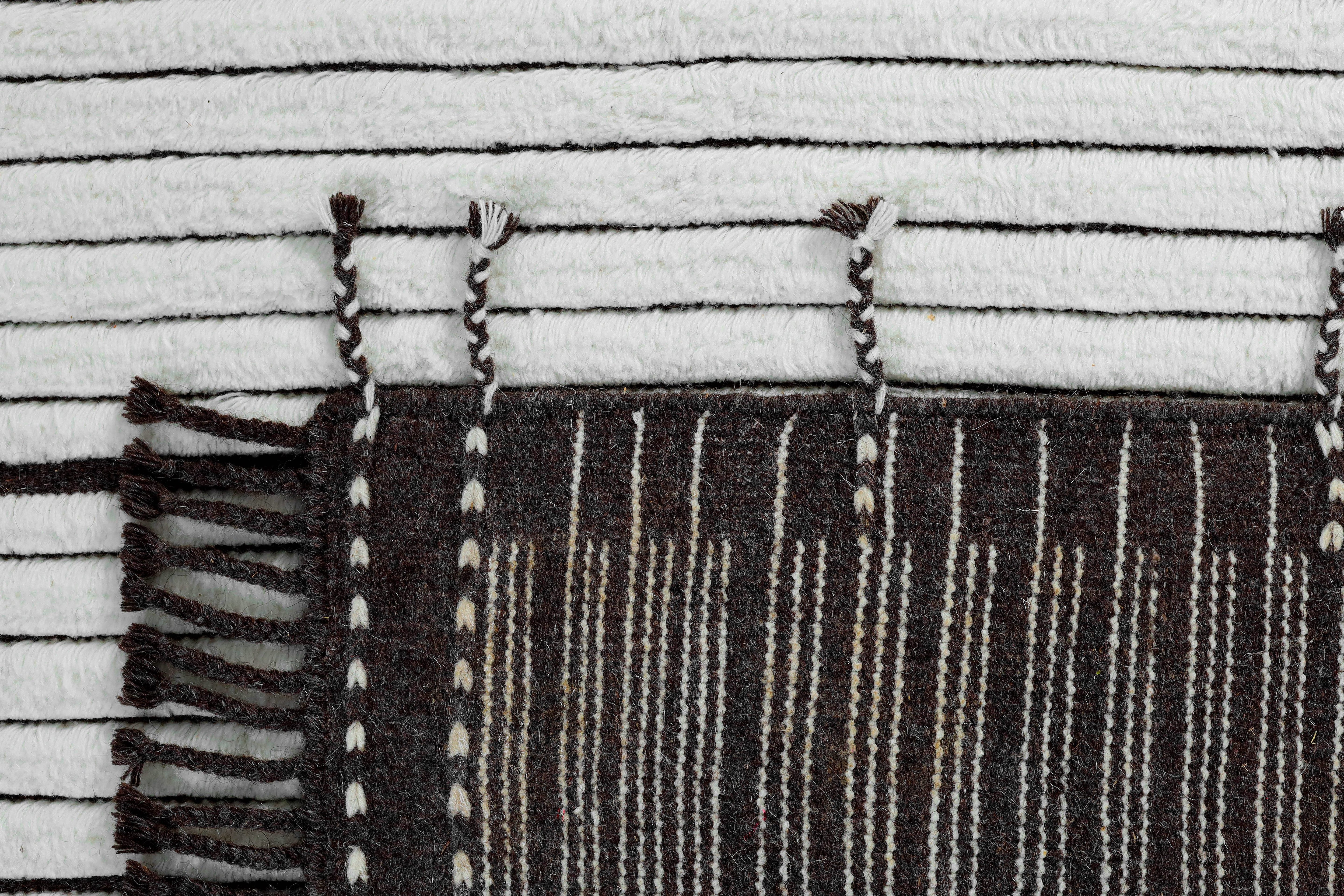 A hand-knotted modern wool rug in a neutral colour combination.