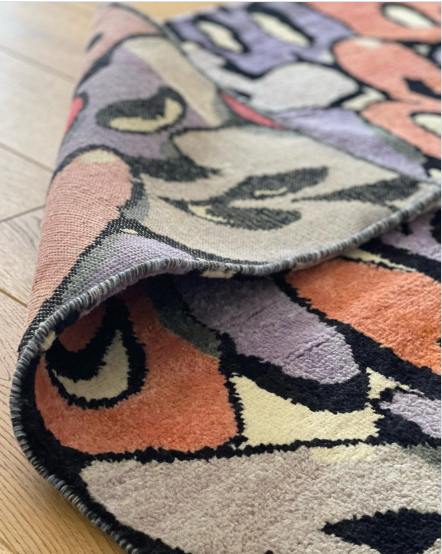A close-up showing the knotting and pile of a hand-knotted custom rug which was made as part of a collaboration between graffiti artist Boogie and Kasra Rugs.