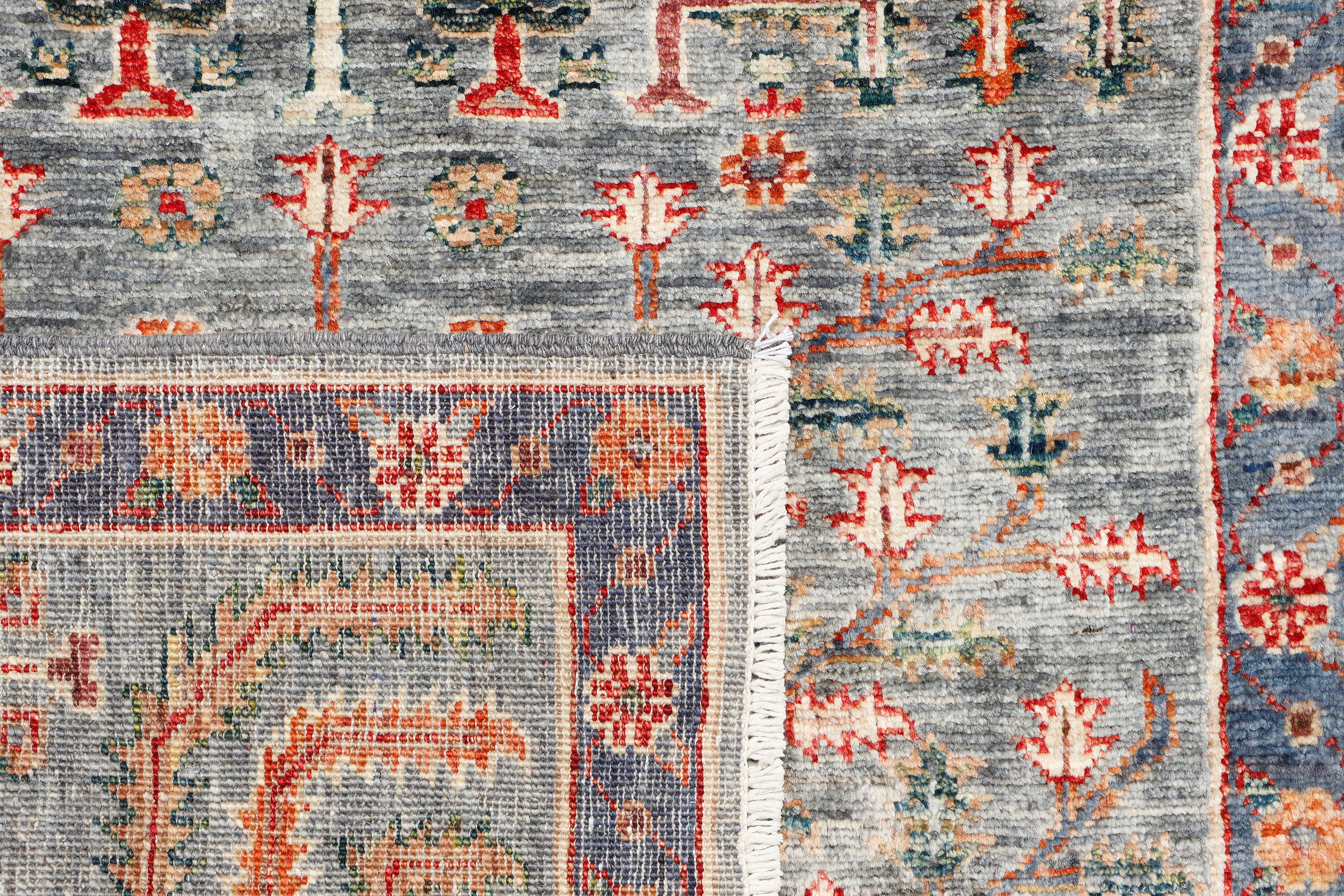 A handmade wool runner rug featuring a classic tribal pattern in a modern colour combination.