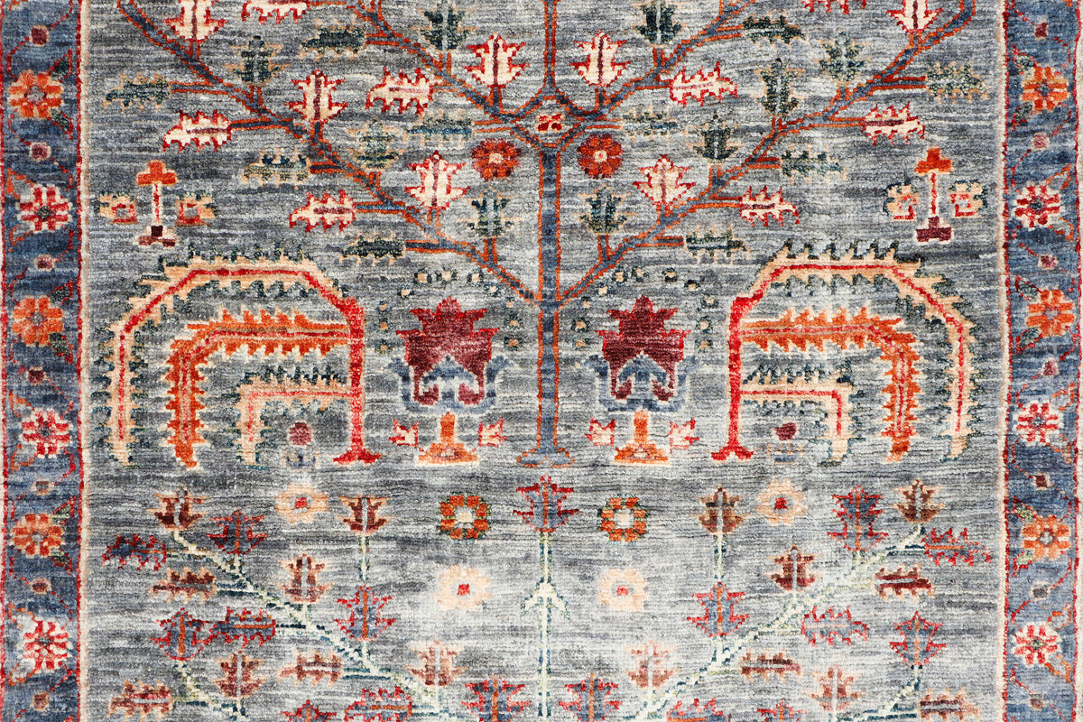 A handmade wool runner rug featuring a classic tribal pattern in a modern colour combination.