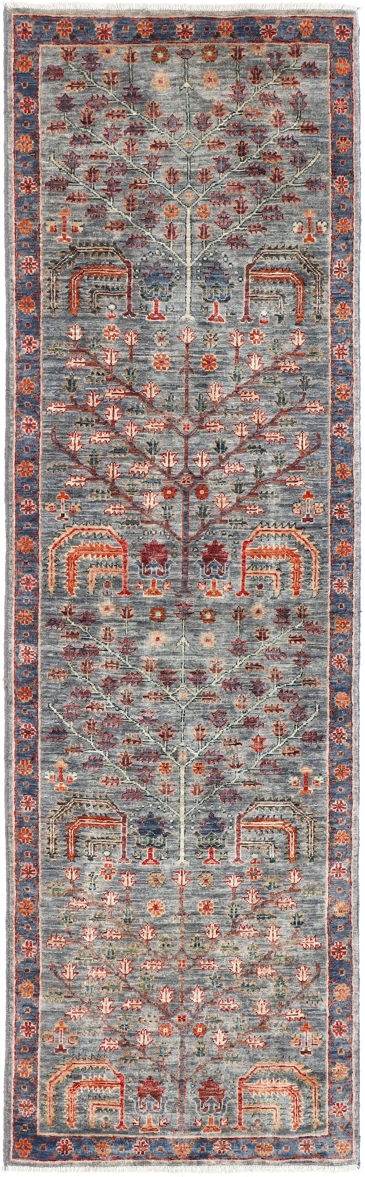 A handmade wool runner rug featuring a classic tribal pattern in a modern colour combination.