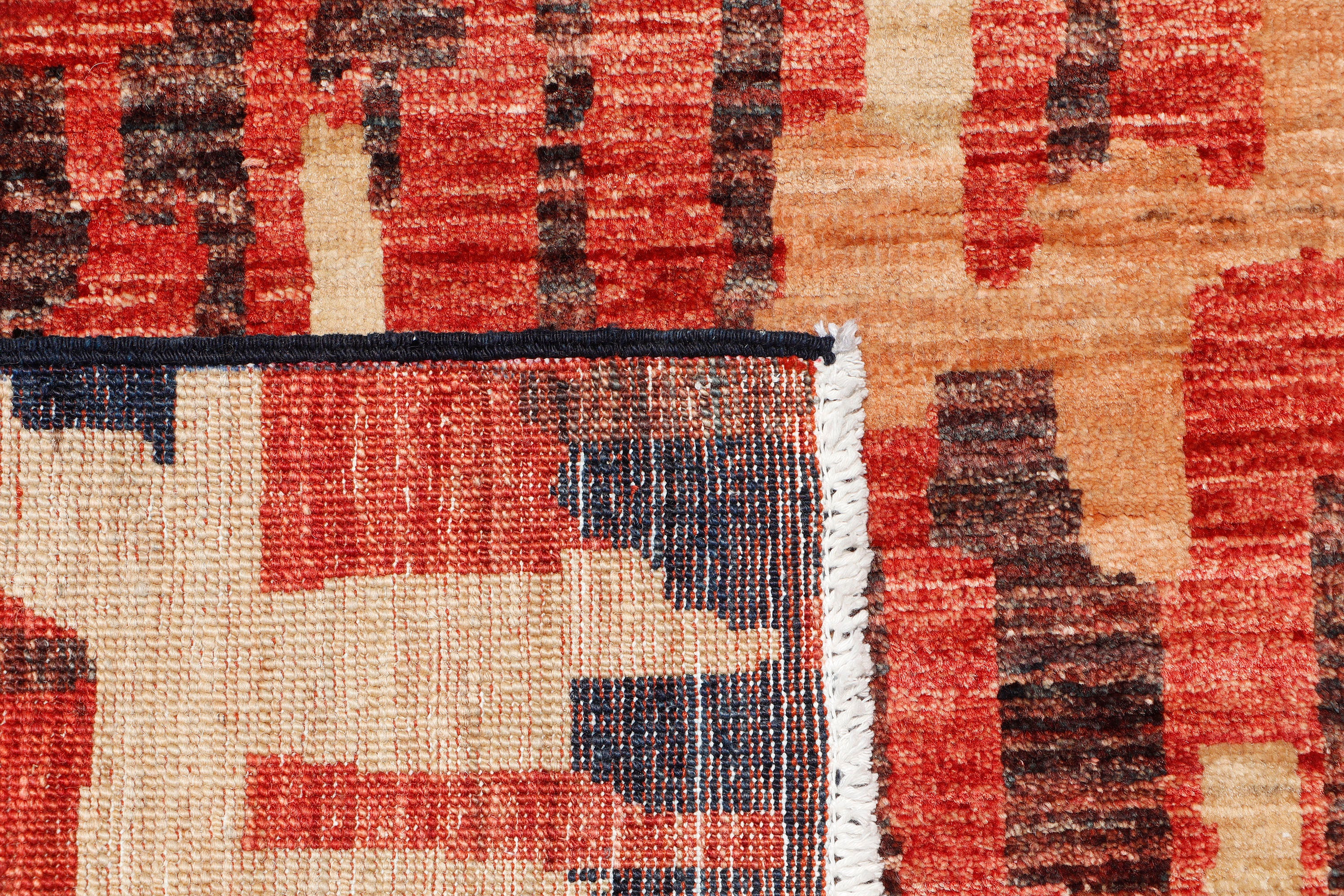 A hand-knotted runner rug featuring a contemporary design.