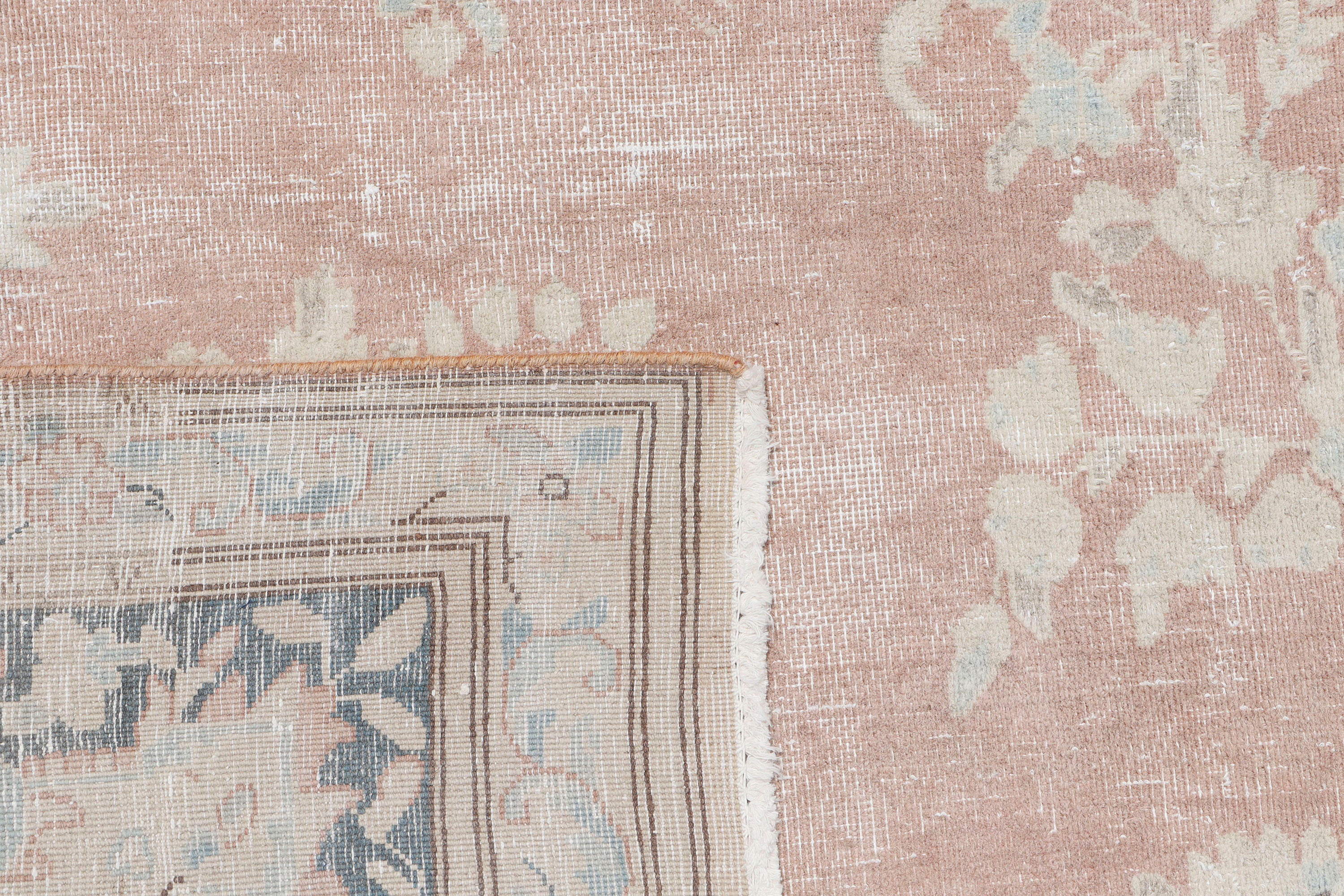 A hand-knotted 10x13 vintage wool rug featuring a blush colour combination.