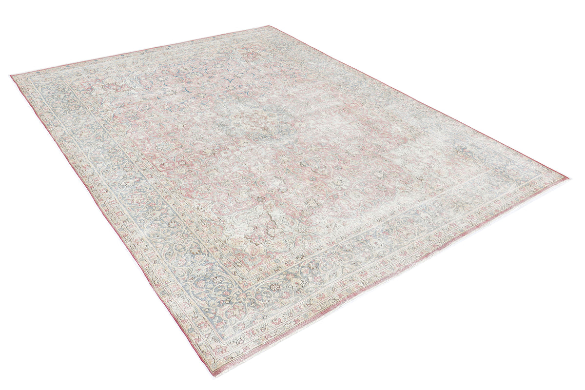 A hand-knotted 9x12 vintage wool rug featuring a classic design in a muted colour palette.