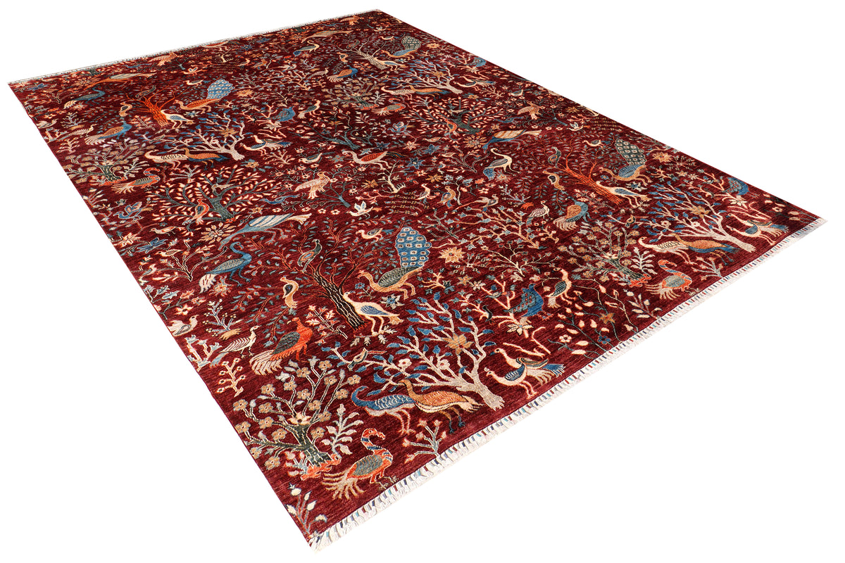 A hand-knotted wool rug with detailed peacock and bird design.