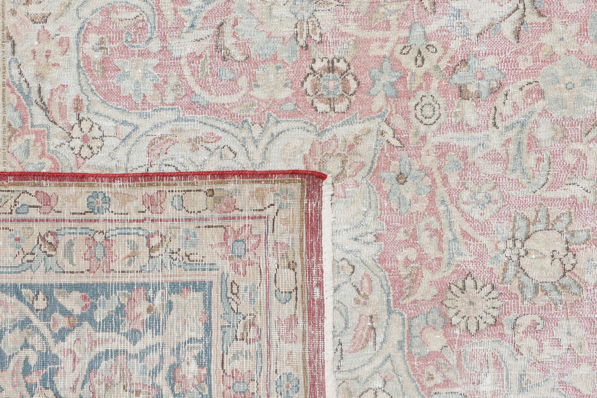 A hand-knotted 9x12 vintage wool rug featuring a classic design in a muted colour palette.