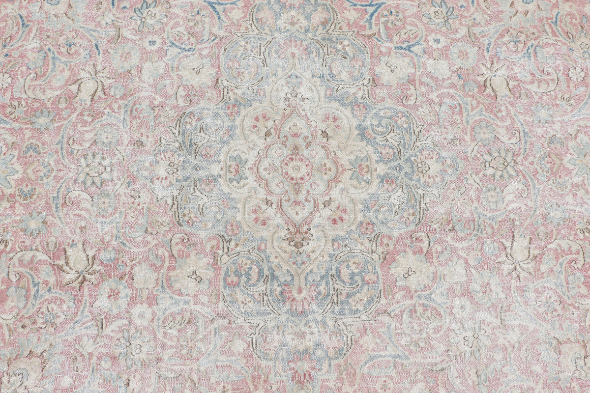 A hand-knotted 9x12 vintage wool rug featuring a classic design in a muted colour palette.