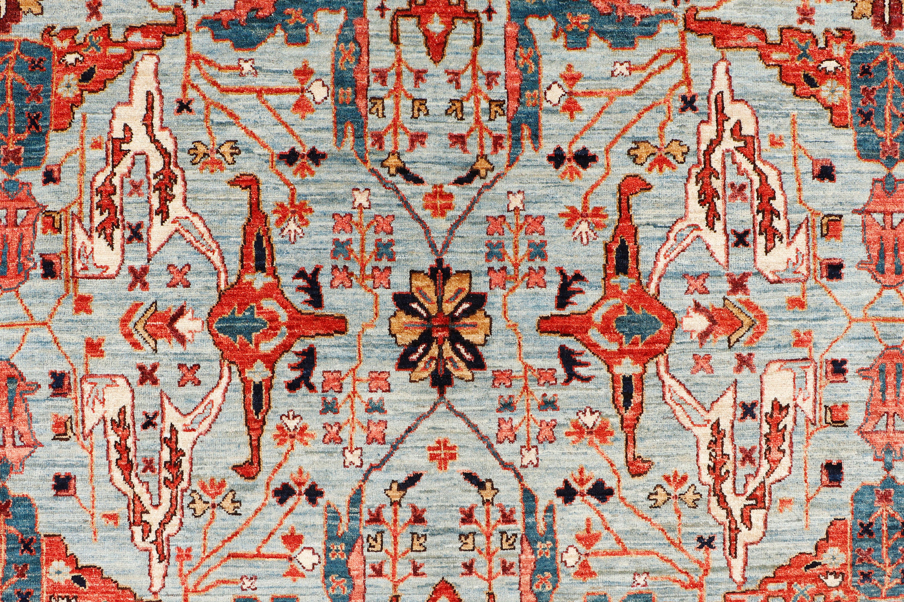 A hand-knotted 8x11 wool rug featuring a classic tribal design in a contemporary colour combination.